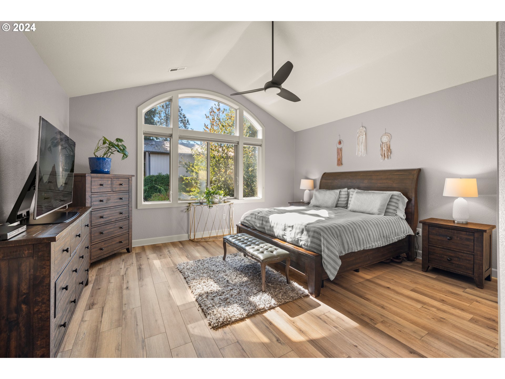 606 Northwest 24th Circle Camas, WA 98607 - Photo 27 of 48 a bedroom with a large bed and a flat tv screen on dresser