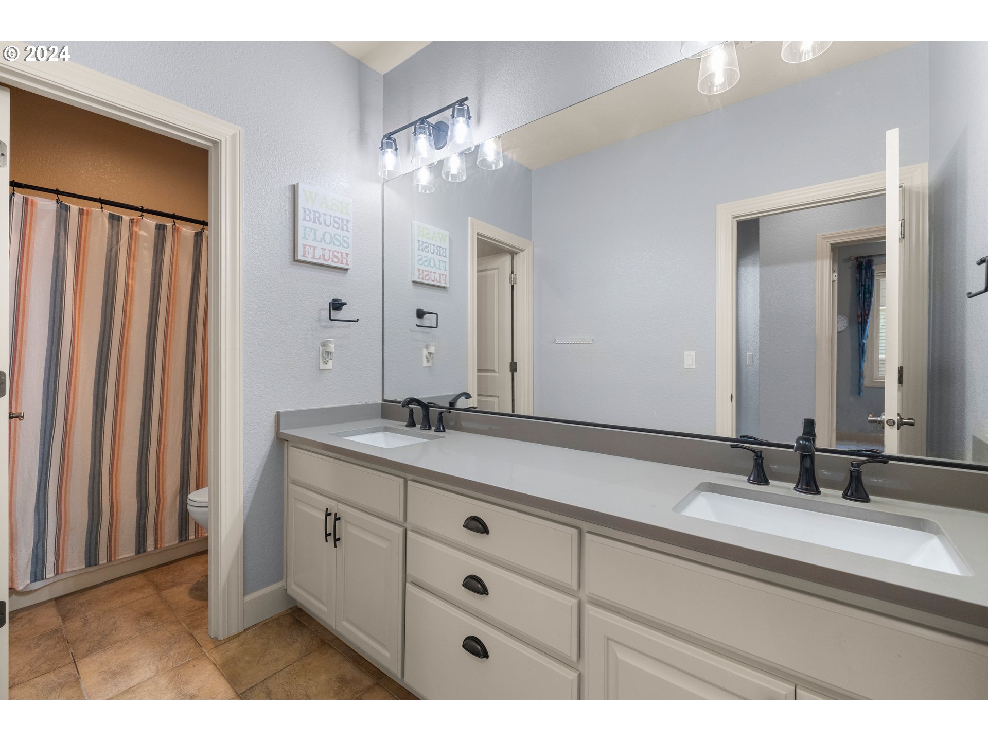 606 Northwest 24th Circle Camas, WA 98607 - Photo 35 of 48 a bathroom with a double vanity sink and a mirror