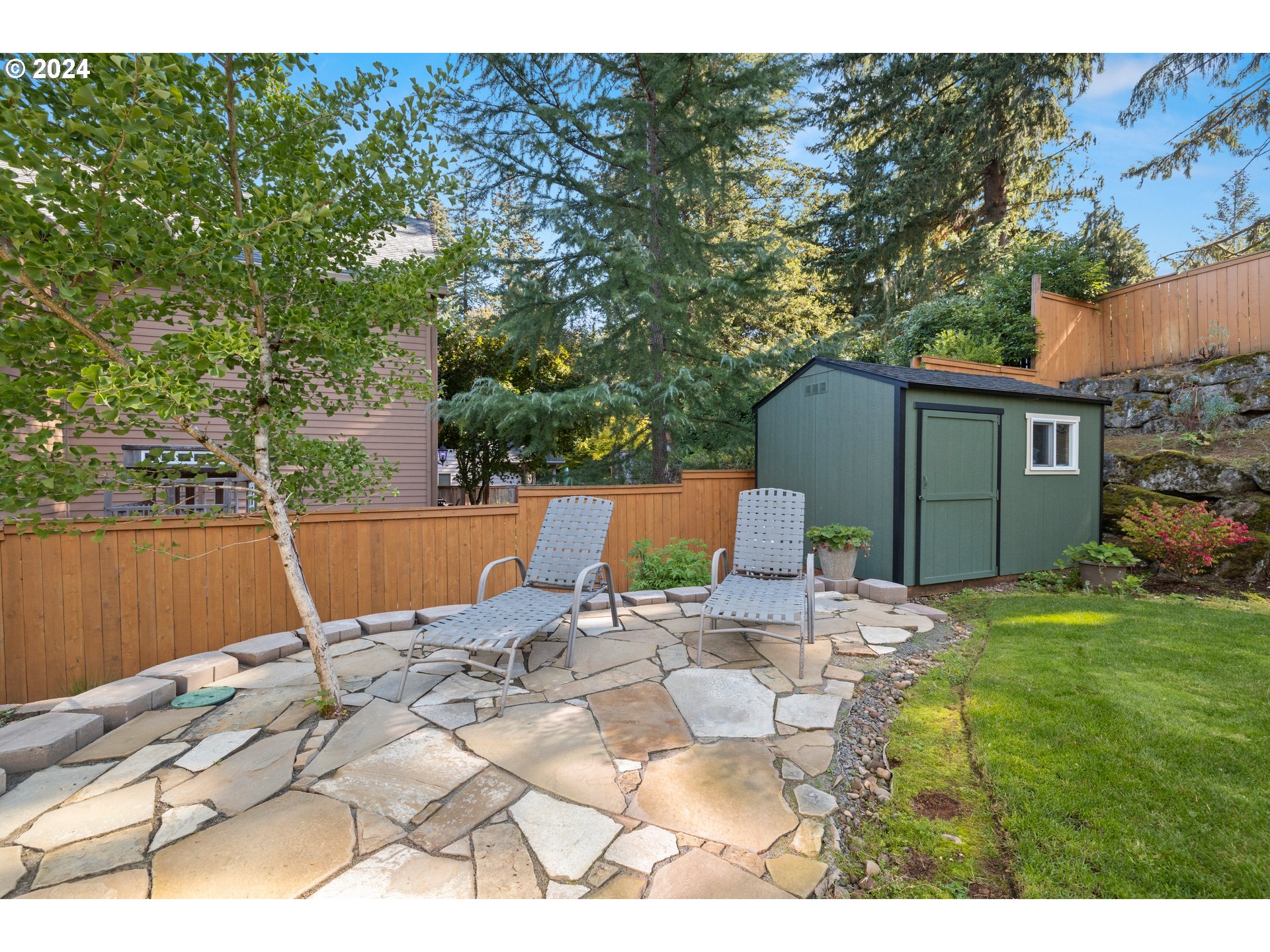 606 Northwest 24th Circle Camas, WA 98607 - Photo 43 of 48 a view of backyard with a table and chairs under an umbrella