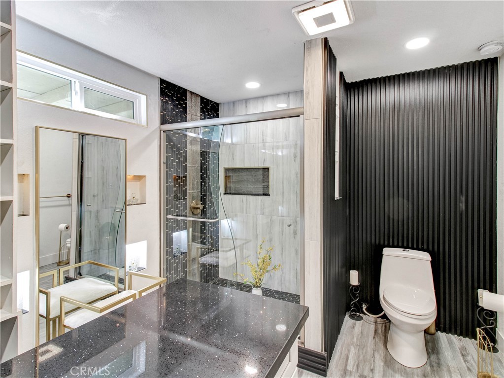 1025 South Riverside Avenue, Unit 26 Rialto, CA 92376 - Photo 19 of 27 a bathroom with a sink a toilet and shower
