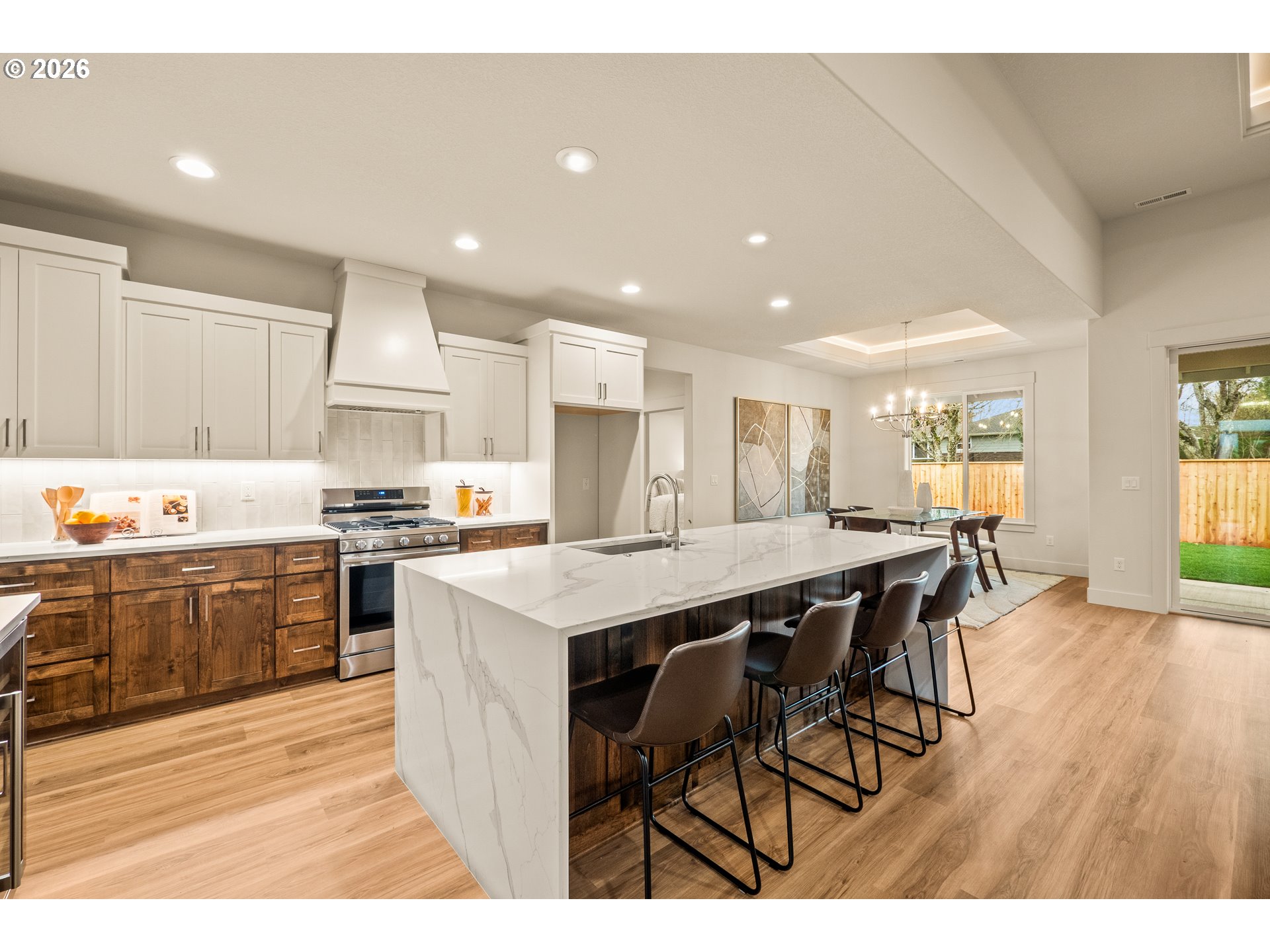 315 Northeast Clay Street Sublimity, OR 97385 - Photo 11 of 42 a kitchen with stainless steel appliances kitchen island granite countertop a table chairs sink and cabinets