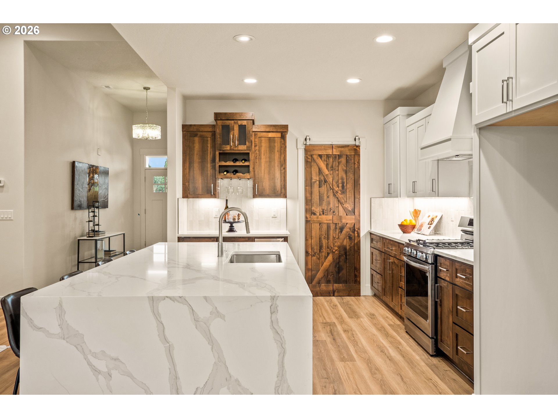 315 Northeast Clay Street Sublimity, OR 97385 - Photo 16 of 42 a large white kitchen with stainless steel appliances kitchen island granite countertop a refrigerator and a sink