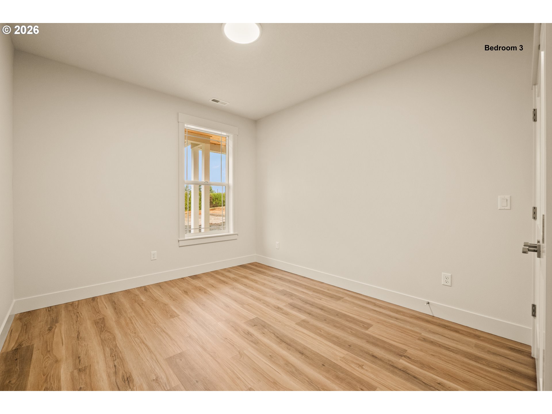 315 Northeast Clay Street Sublimity, OR 97385 - Photo 29 of 42 a view of an empty room with wooden floor and a window