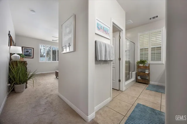a view of a hallway with a livingroom and furniture