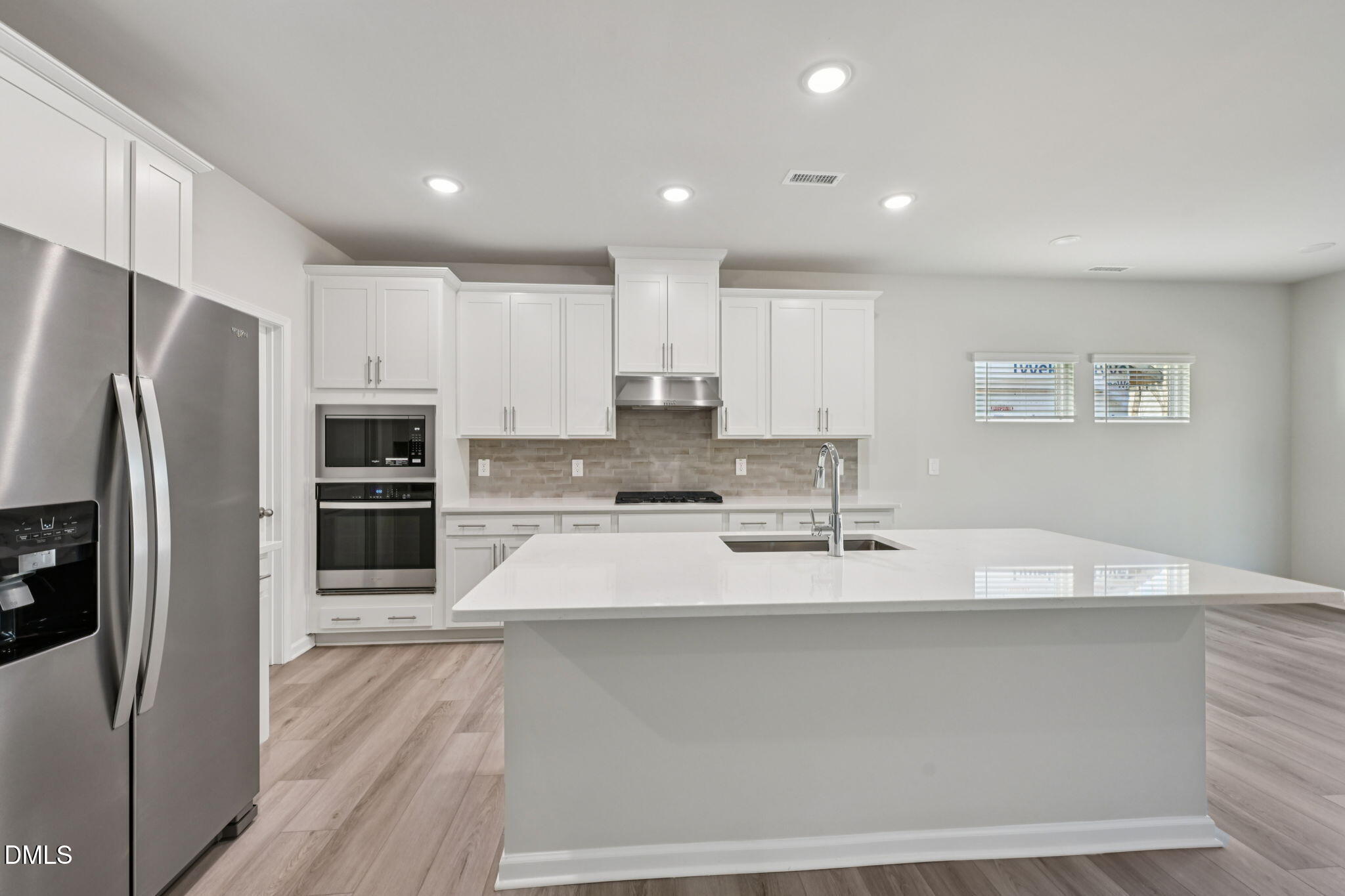 2145 Topsail Road Durham, NC 27703 - Photo 15 of 49 a large kitchen with granite countertop a large counter top stainless steel appliances and cabinets