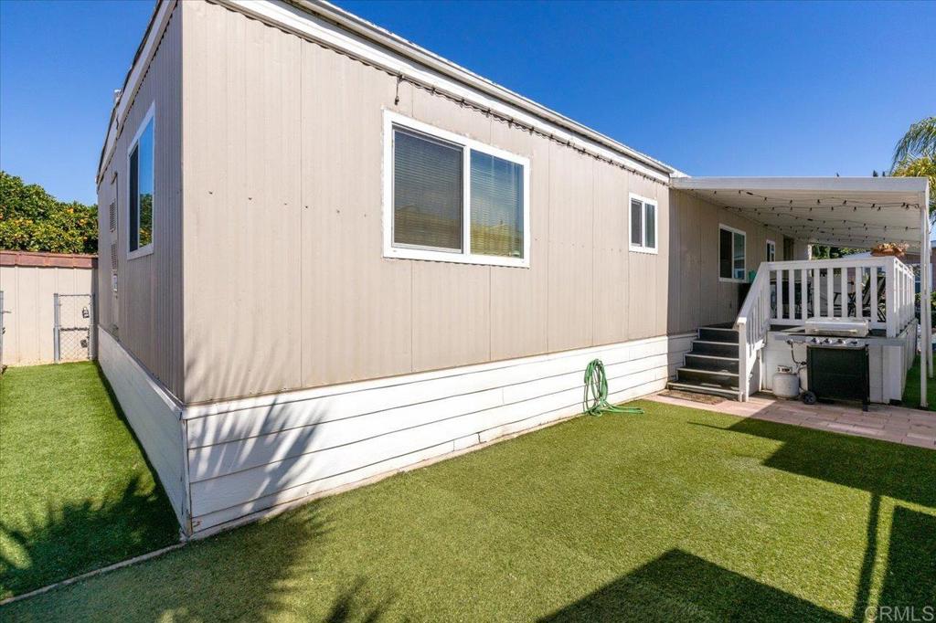 4660 North River Road, Unit 150 Oceanside, CA 92057 - Photo 19 of 23 a view of a house with a backyard