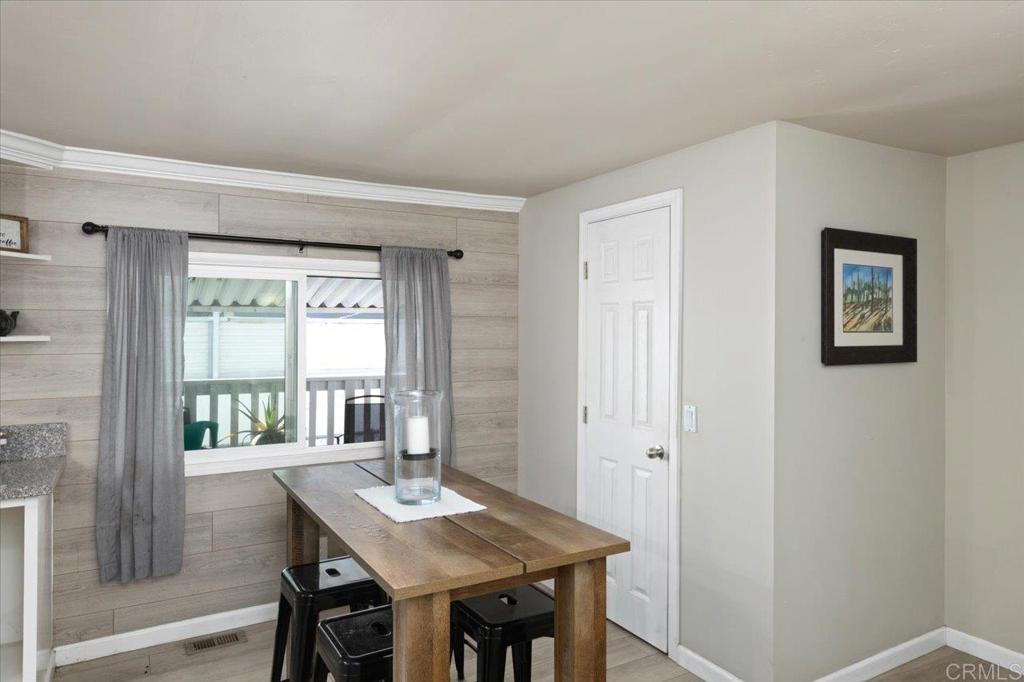 4660 North River Road, Unit 150 Oceanside, CA 92057 - Photo 9 of 23 a view of a dining room with furniture window and wooden floor