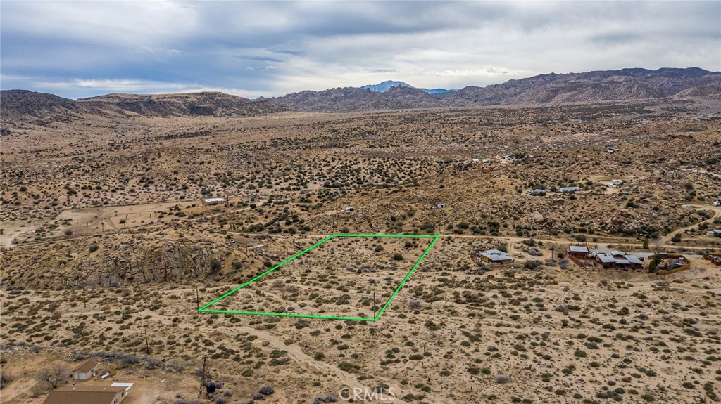 52500 Riverside Drive Pioneertown, CA 92268 - Photo 19 of 23 a view of a dry yard with mountains in the background
