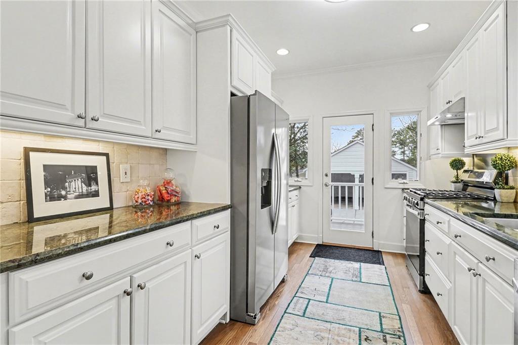 1746 Johnson Road Northeast Atlanta, GA 30306 - Photo 18 of 45 a kitchen with granite countertop white cabinets and stainless steel appliances