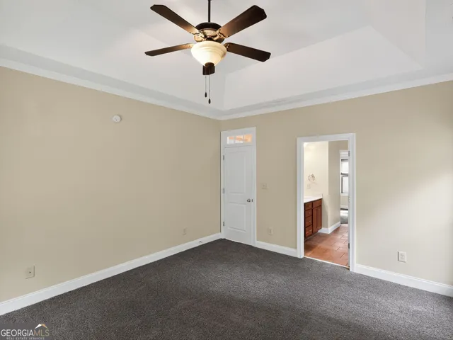 wooden floor in an empty room and a ceiling fan