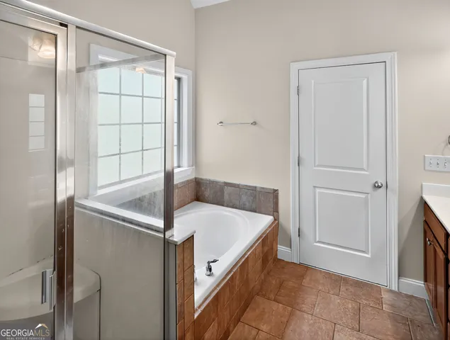 a bathroom with a tub and shower