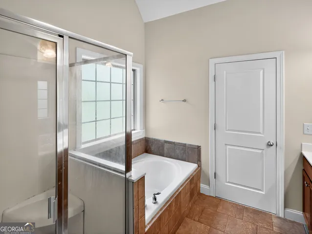 a bathroom with a tub and shower