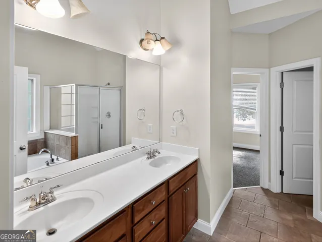 a bathroom with a double vanity sink and a mirror