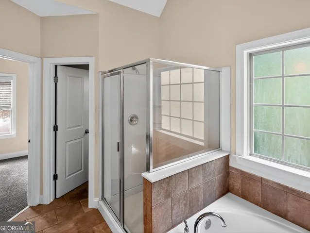 a bathroom with a tub and shower