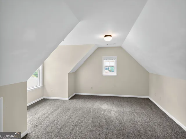 an empty room with a empty space and windows