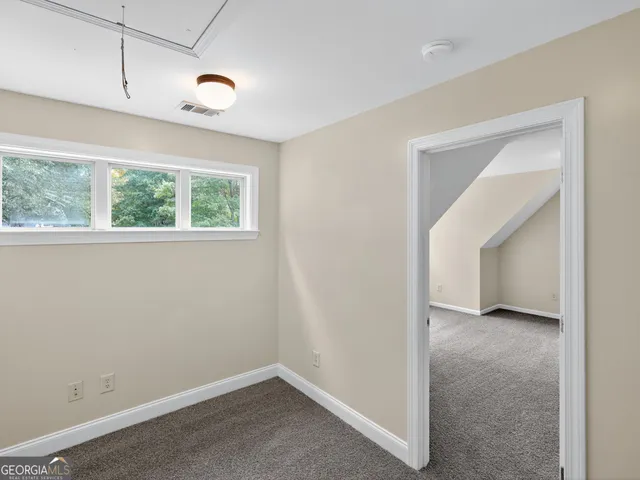 an empty room with windows and closet