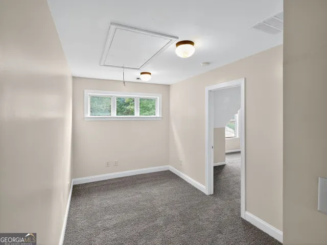 an empty room with windows and closet