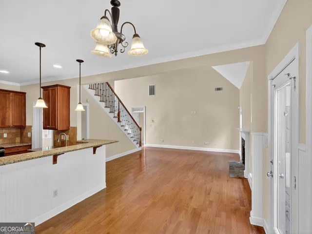 a view of a room with wooden floor and staircase