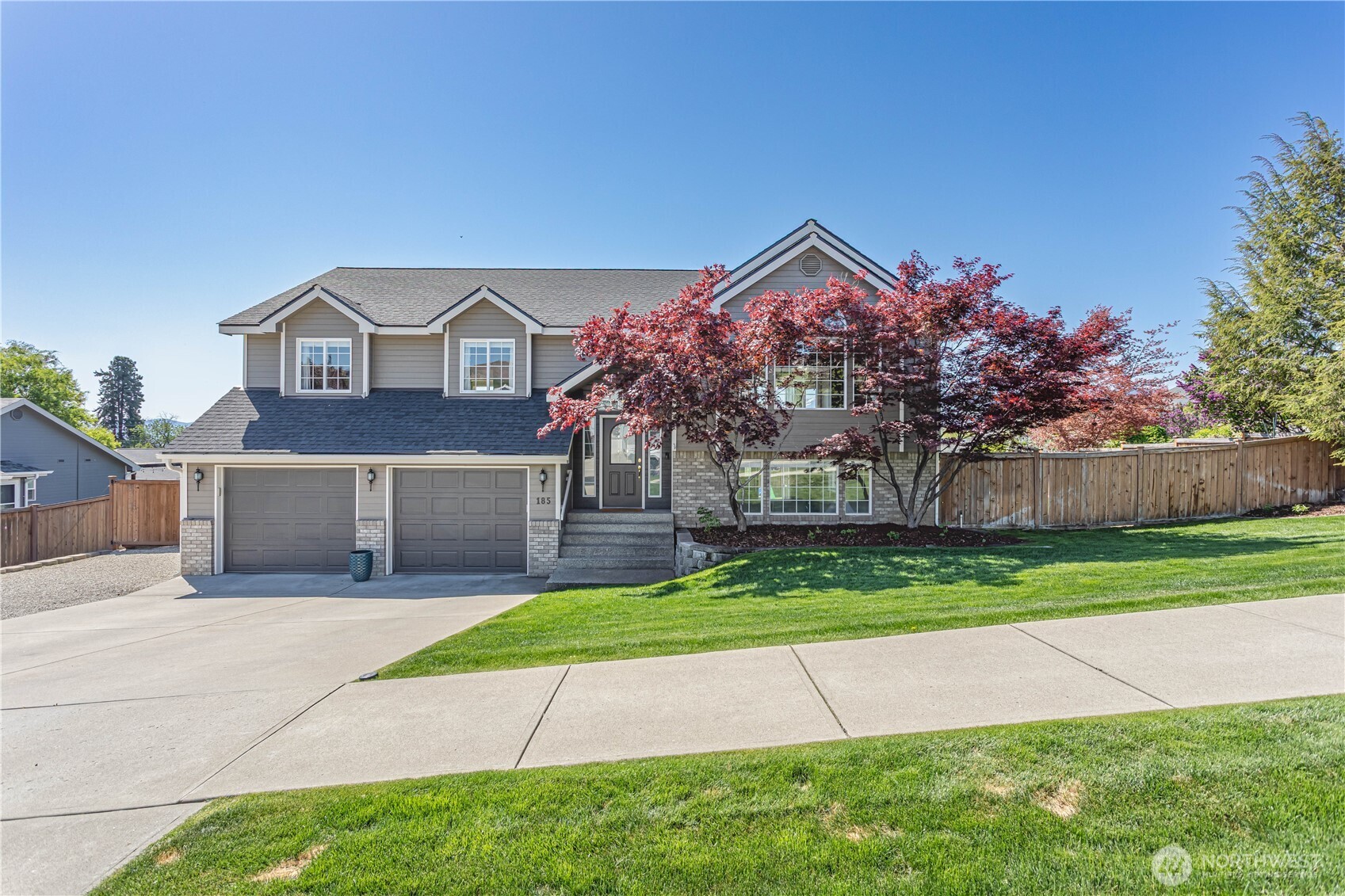 a front view of house with yard and green space