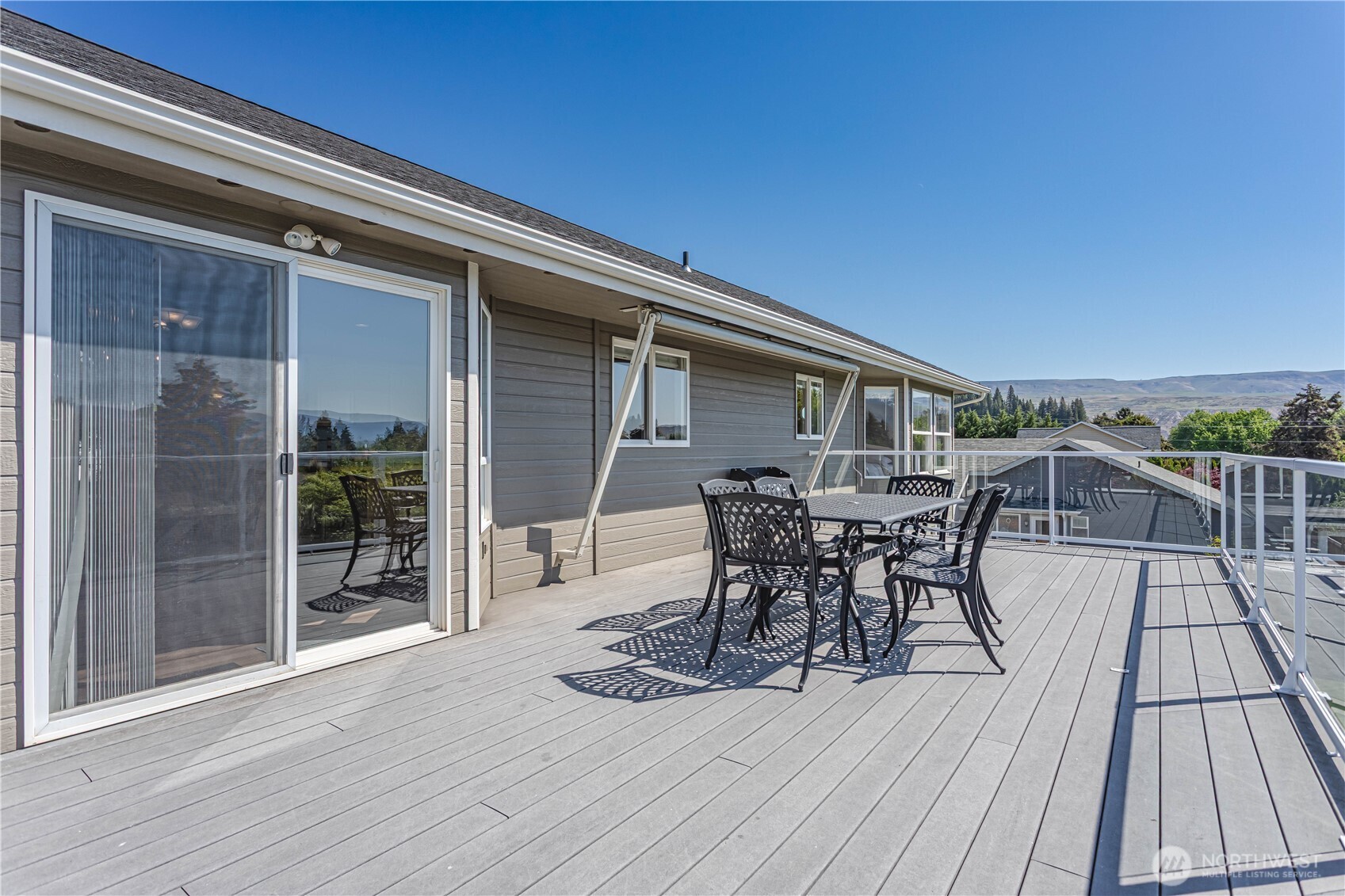 185 Fox Run Wenatchee, WA 98801 - Photo 37 of 39 a view of a roof deck with table and chairs a barbeque with wooden floor and fence