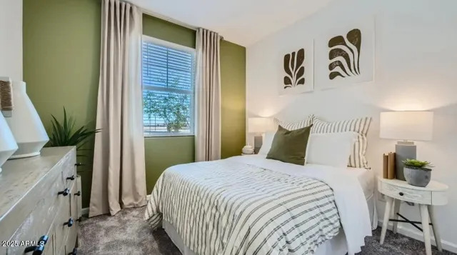 a bedroom with a bed and a mirror