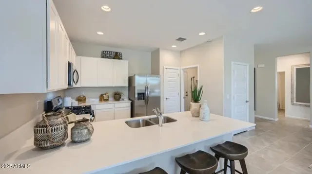 a kitchen with refrigerator and cabinets