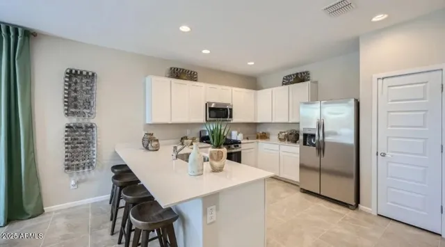 a kitchen with stainless steel appliances a refrigerator sink and cabinets