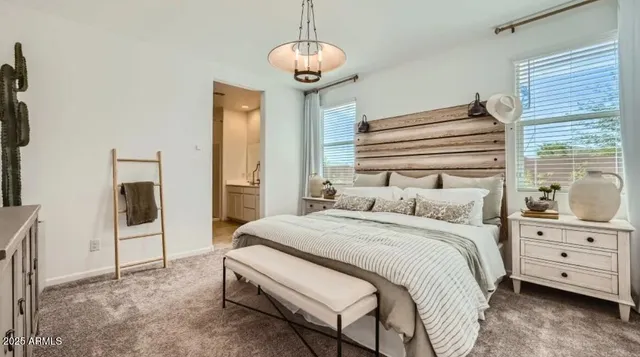 a bedroom with a bed and a chandelier