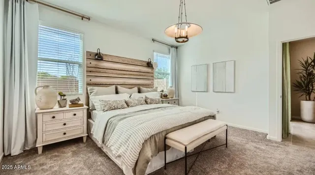 a bedroom with a bed and a chandelier