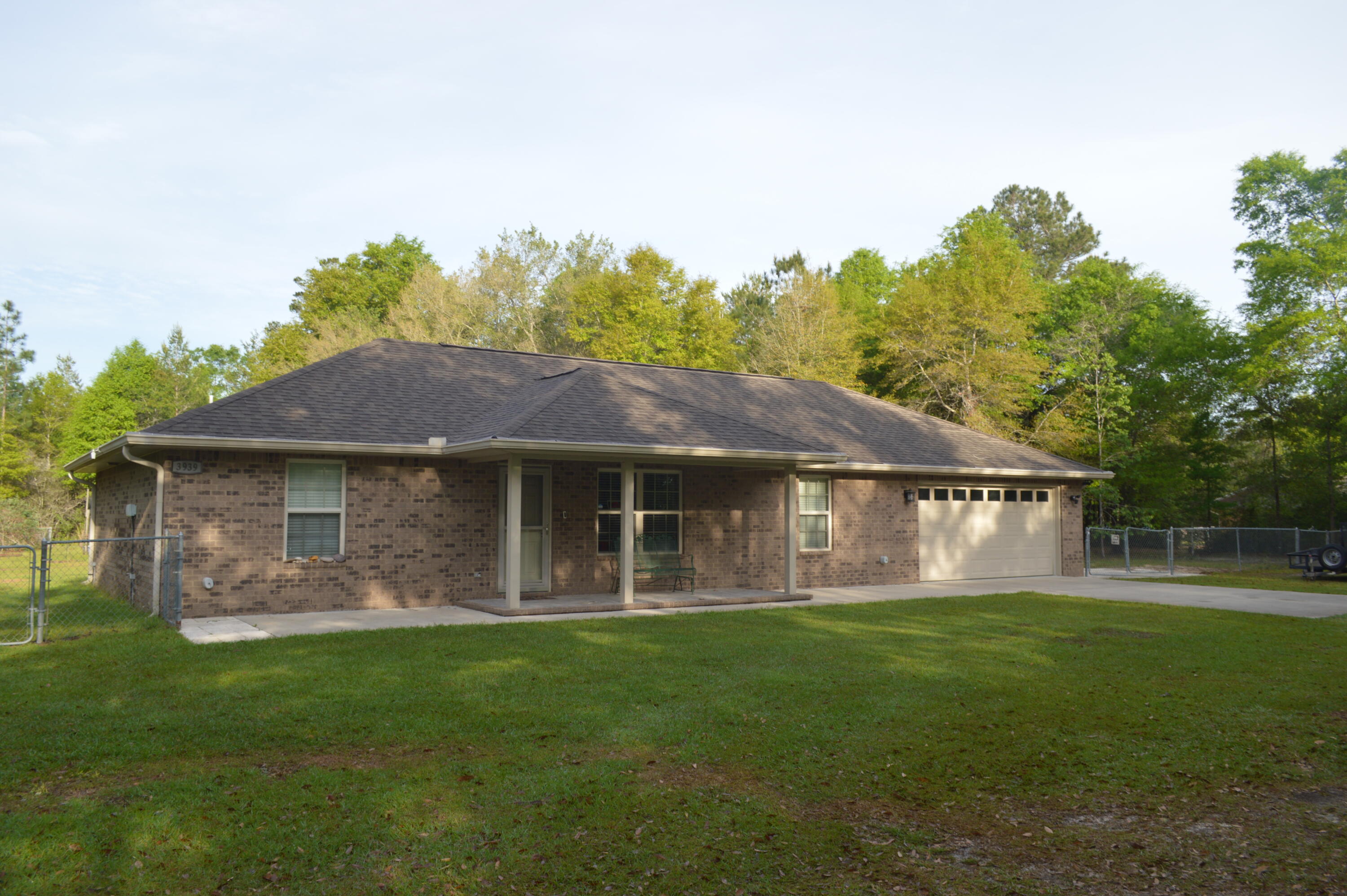 3939 Painter Branch Road Crestview, FL 32539 - Photo 1 of 35 a front view of a house with a garden