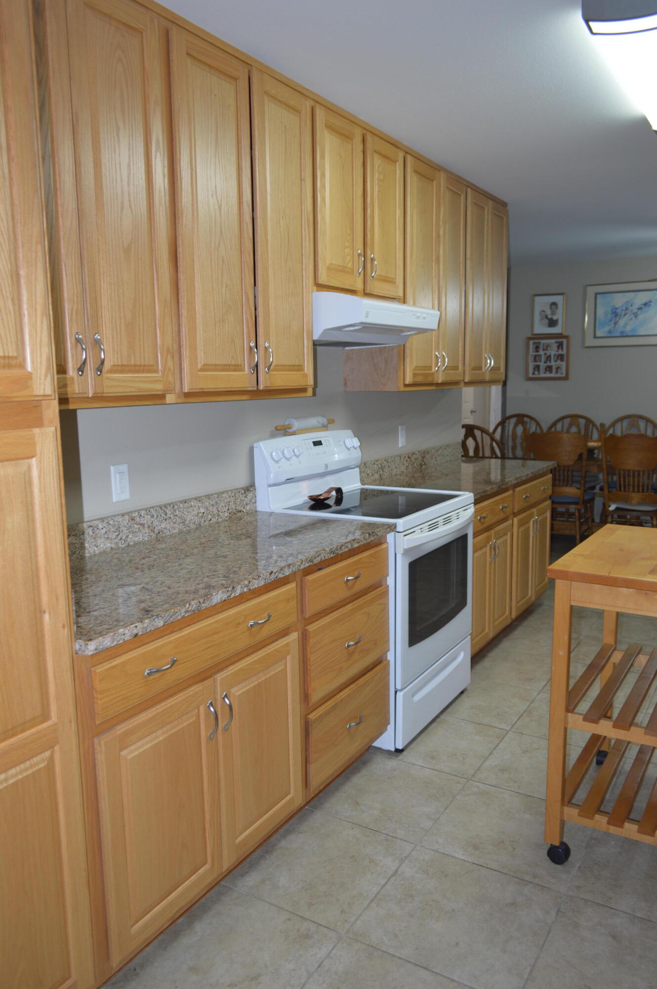 3939 Painter Branch Road Crestview, FL 32539 - Photo 11 of 35 a kitchen with stainless steel appliances granite countertop a stove a sink and a refrigerator