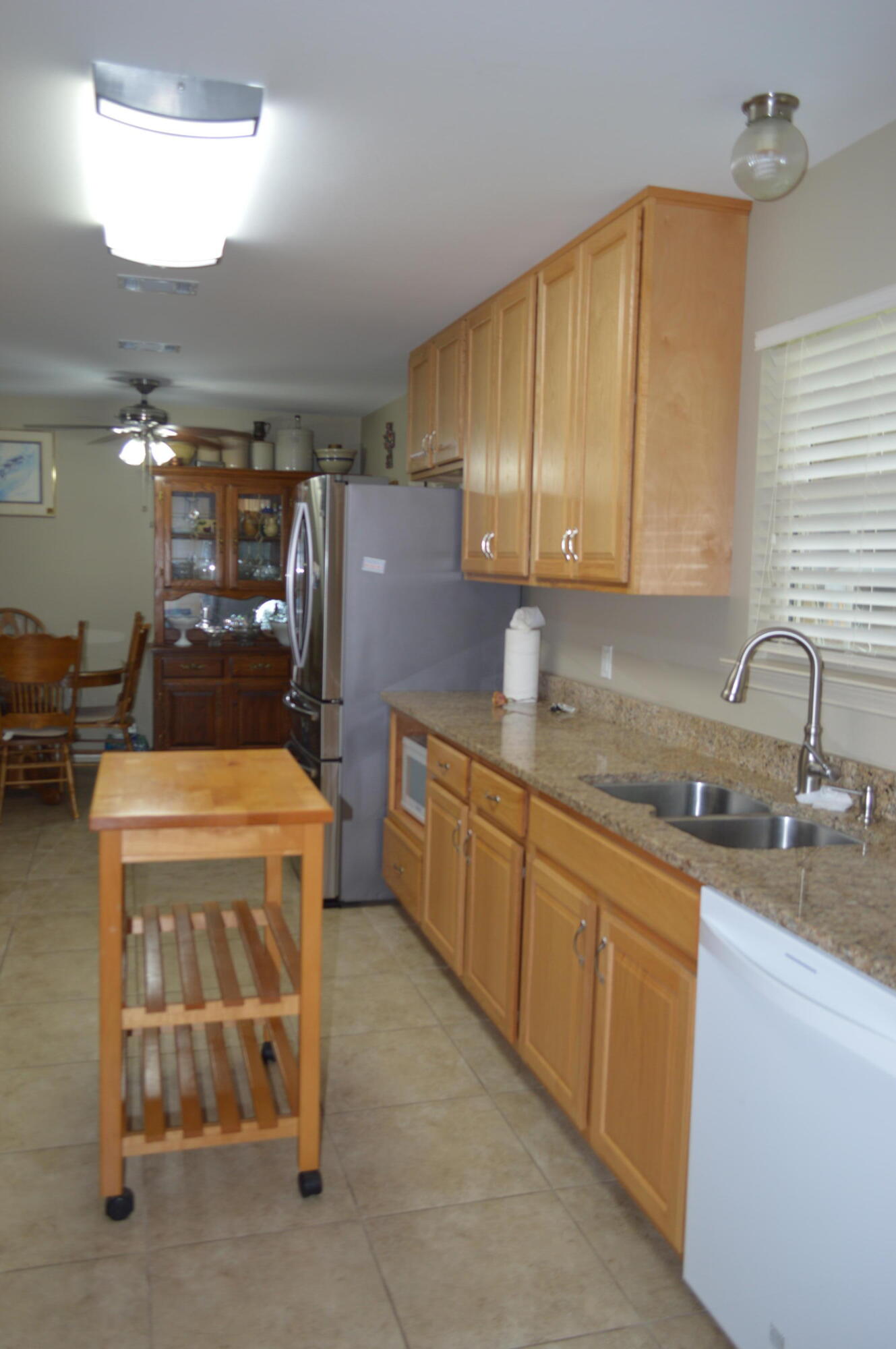 3939 Painter Branch Road Crestview, FL 32539 - Photo 12 of 35 a kitchen with stainless steel appliances granite countertop a sink stove and refrigerator