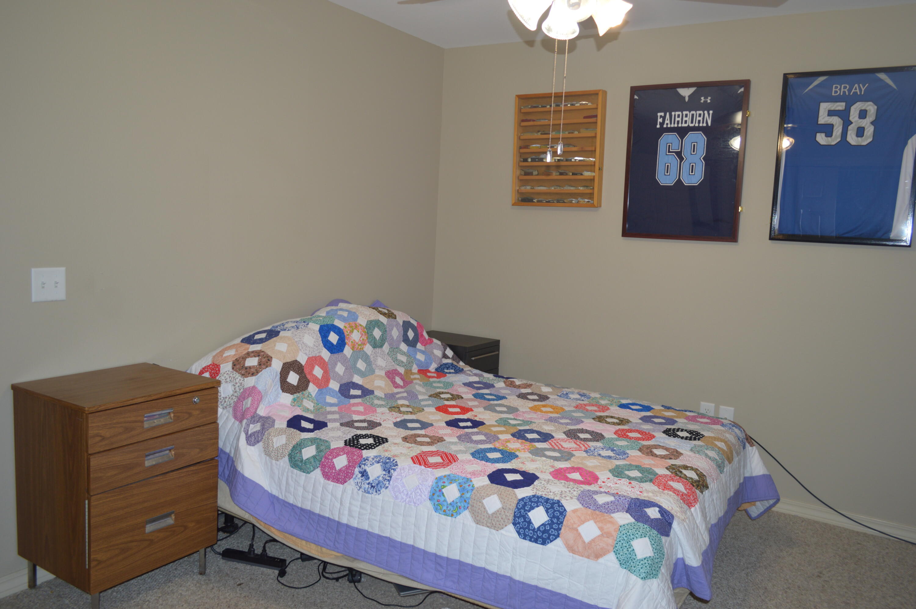 3939 Painter Branch Road Crestview, FL 32539 - Photo 13 of 35 a bedroom with a bed and a lamp on dresser