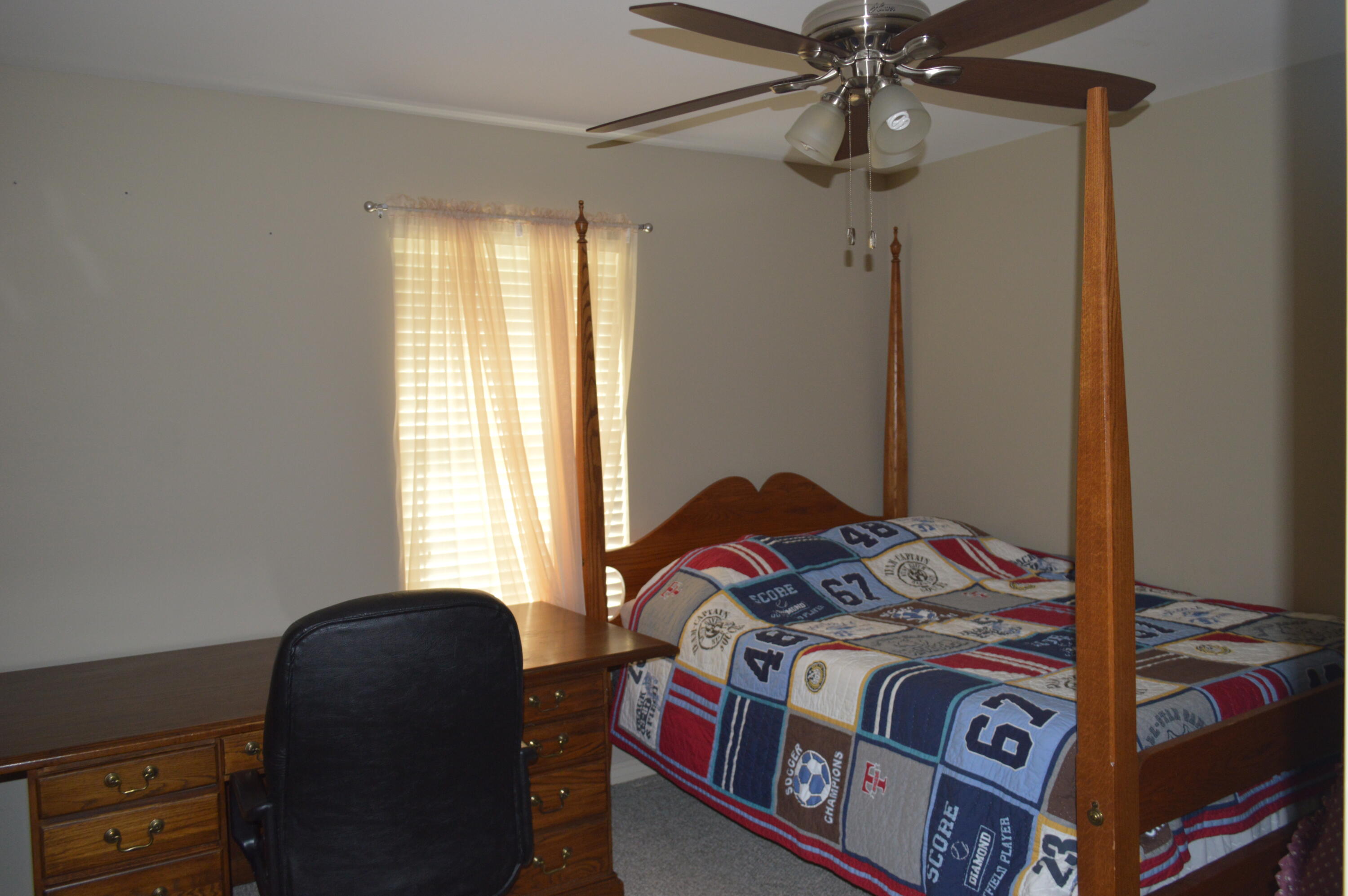 3939 Painter Branch Road Crestview, FL 32539 - Photo 15 of 35 a bedroom with a bed and a window