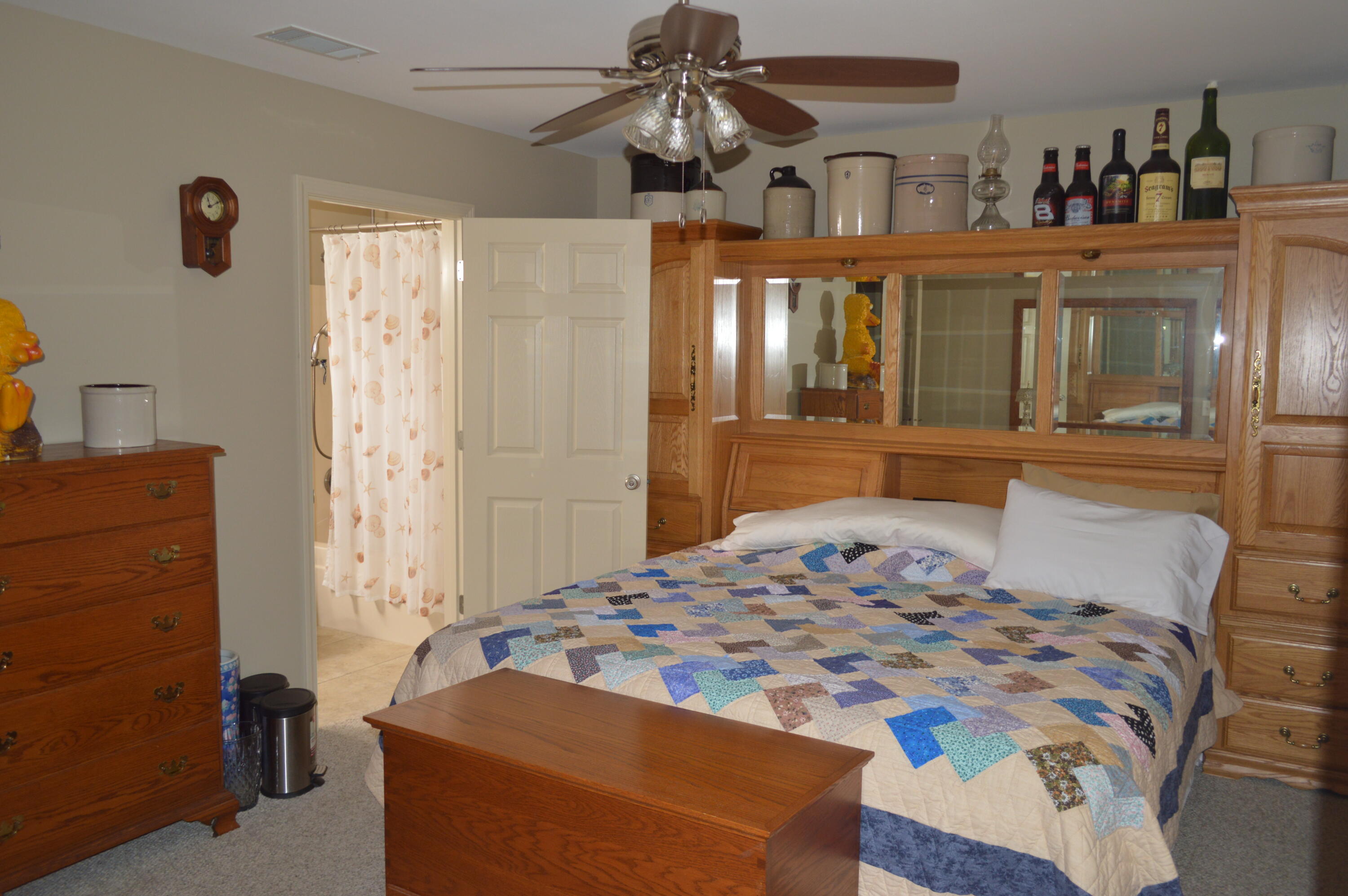 3939 Painter Branch Road Crestview, FL 32539 - Photo 17 of 35 a bedroom with a bed and a chandelier
