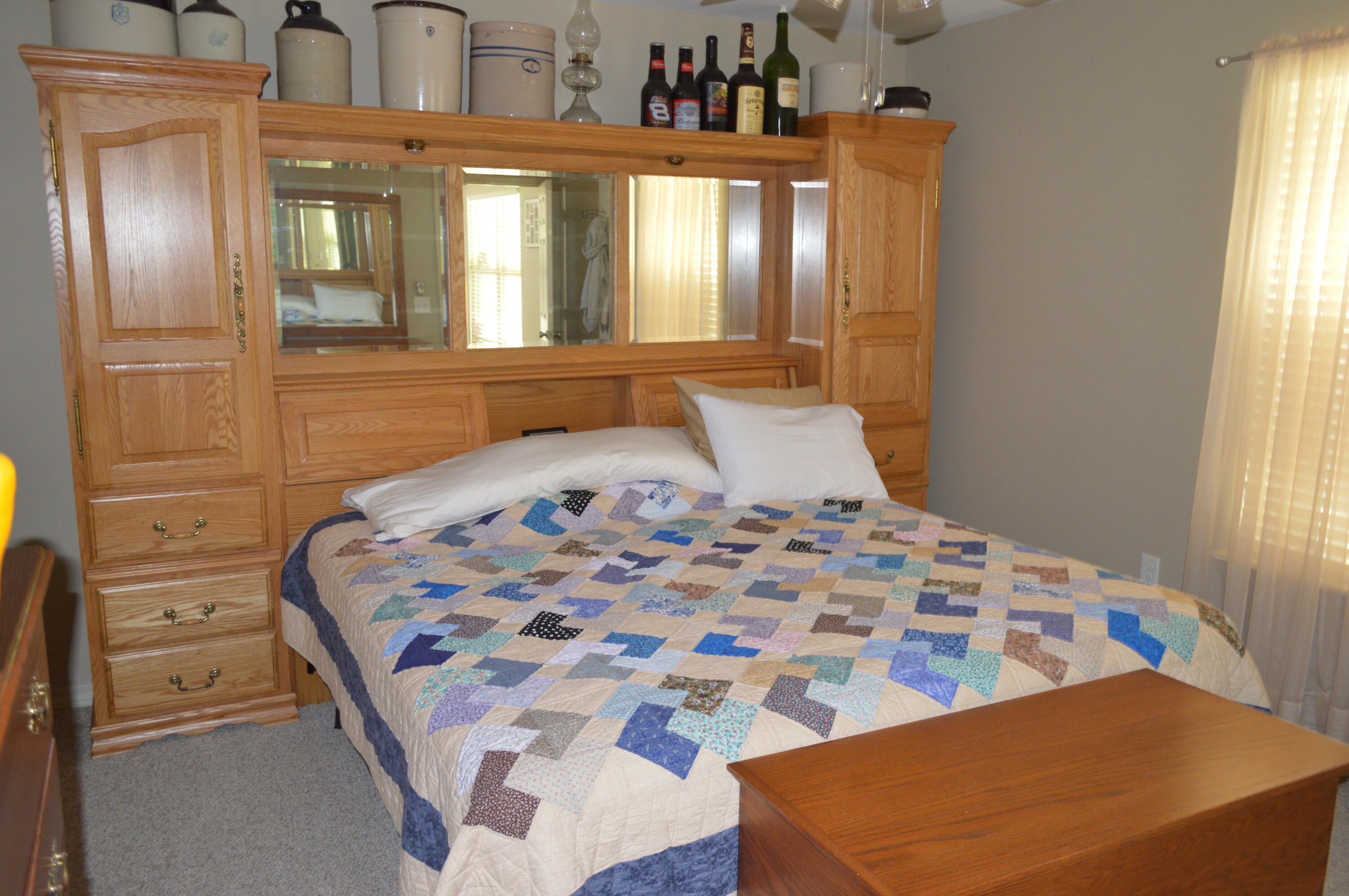 3939 Painter Branch Road Crestview, FL 32539 - Photo 18 of 35 a bedroom with a large bed and a chandelier