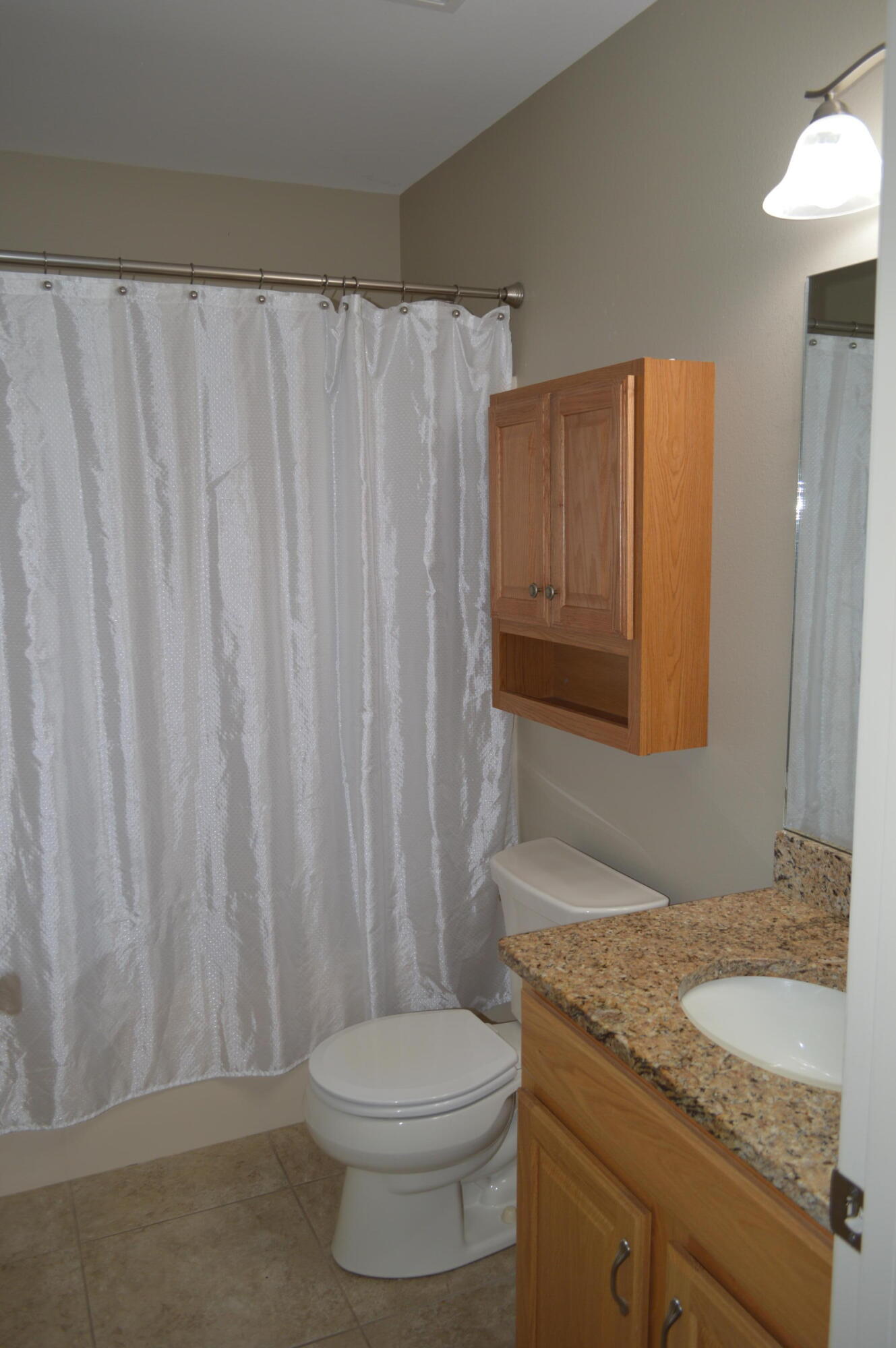 3939 Painter Branch Road Crestview, FL 32539 - Photo 19 of 35 a bathroom with a granite countertop toilet and a sink