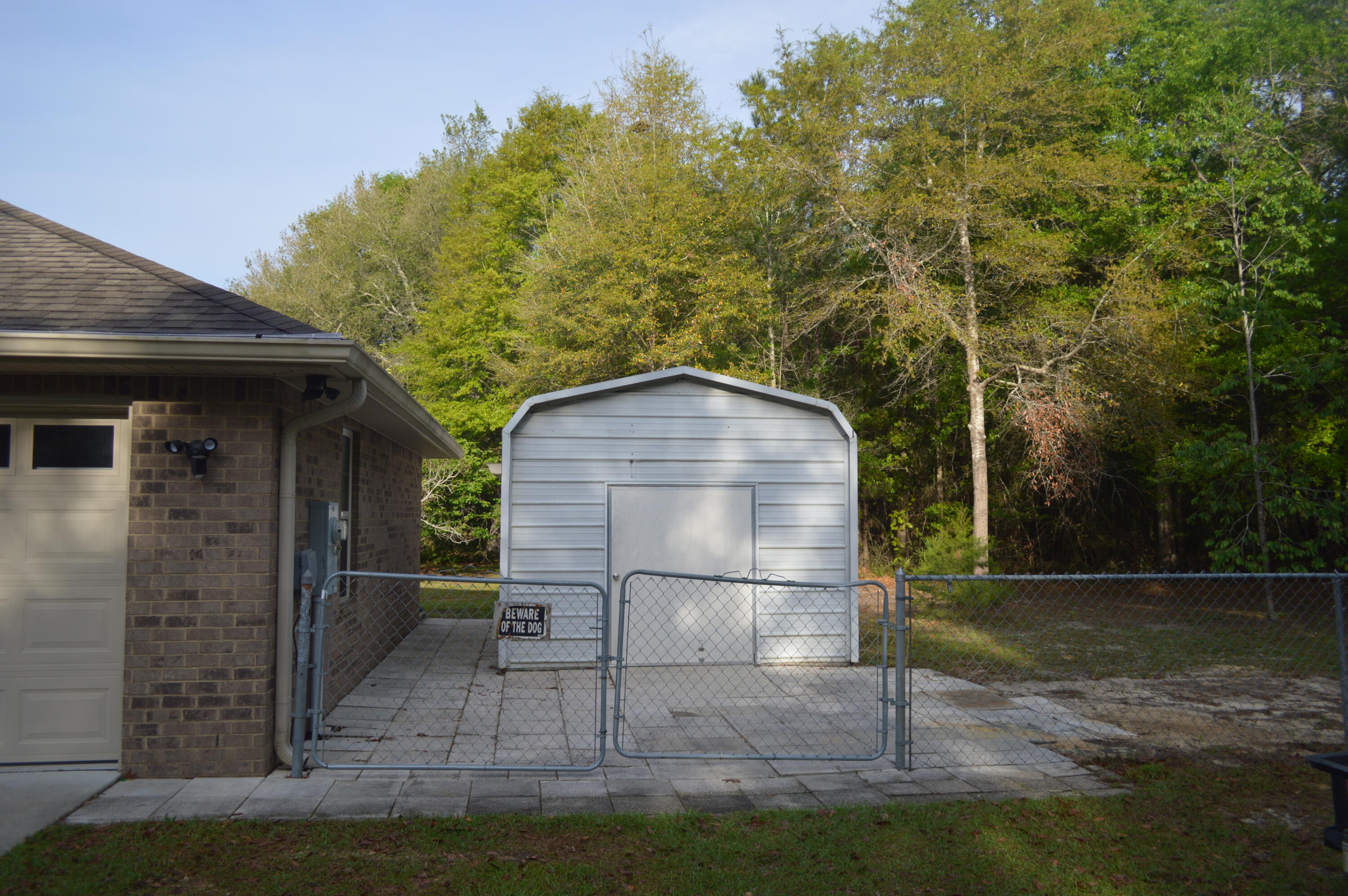 3939 Painter Branch Road Crestview, FL 32539 - Photo 25 of 35 a view of backyard with wooden fence and trees