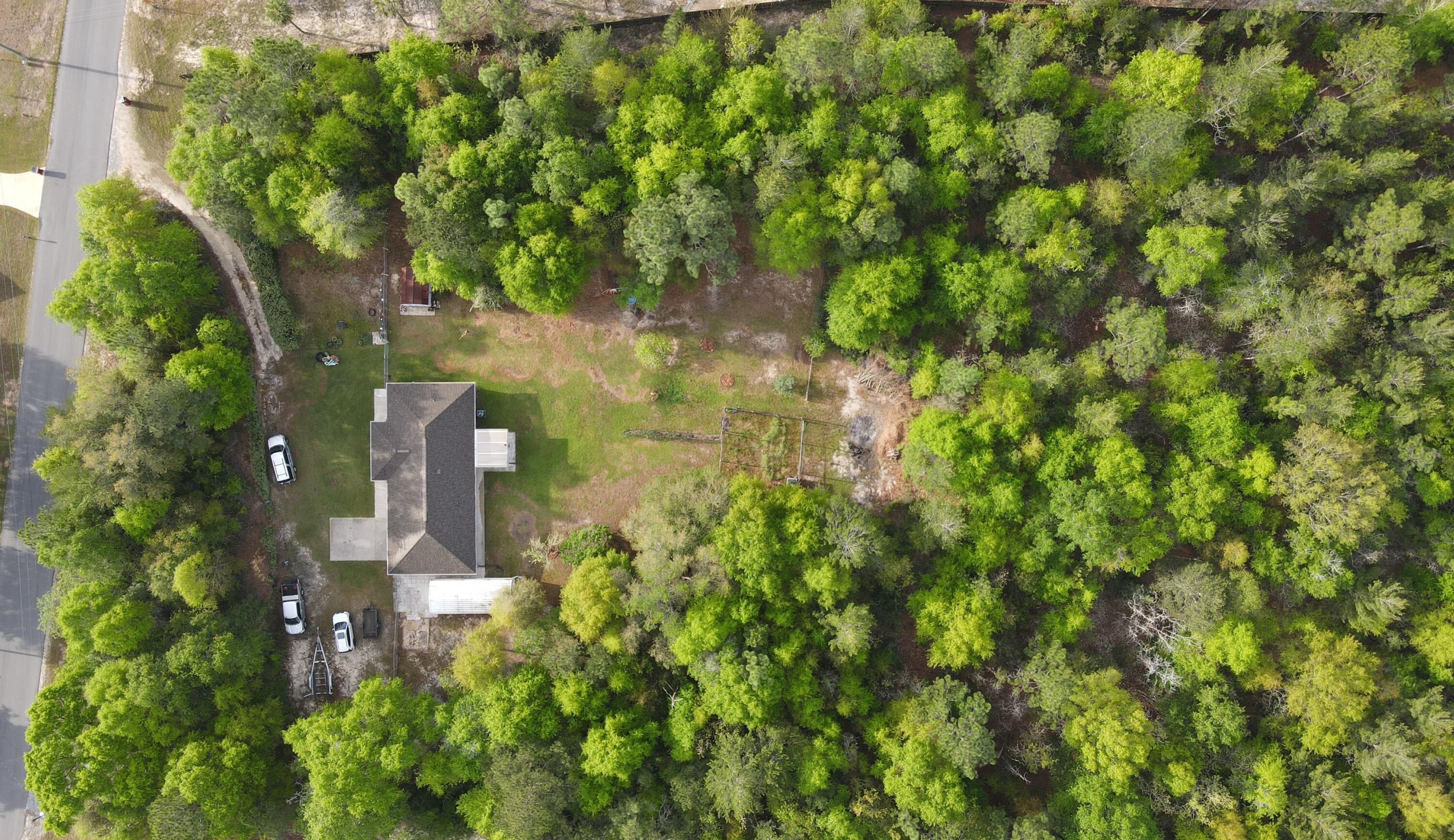 3939 Painter Branch Road Crestview, FL 32539 - Photo 34 of 35 a backyard of a house with lots of green space