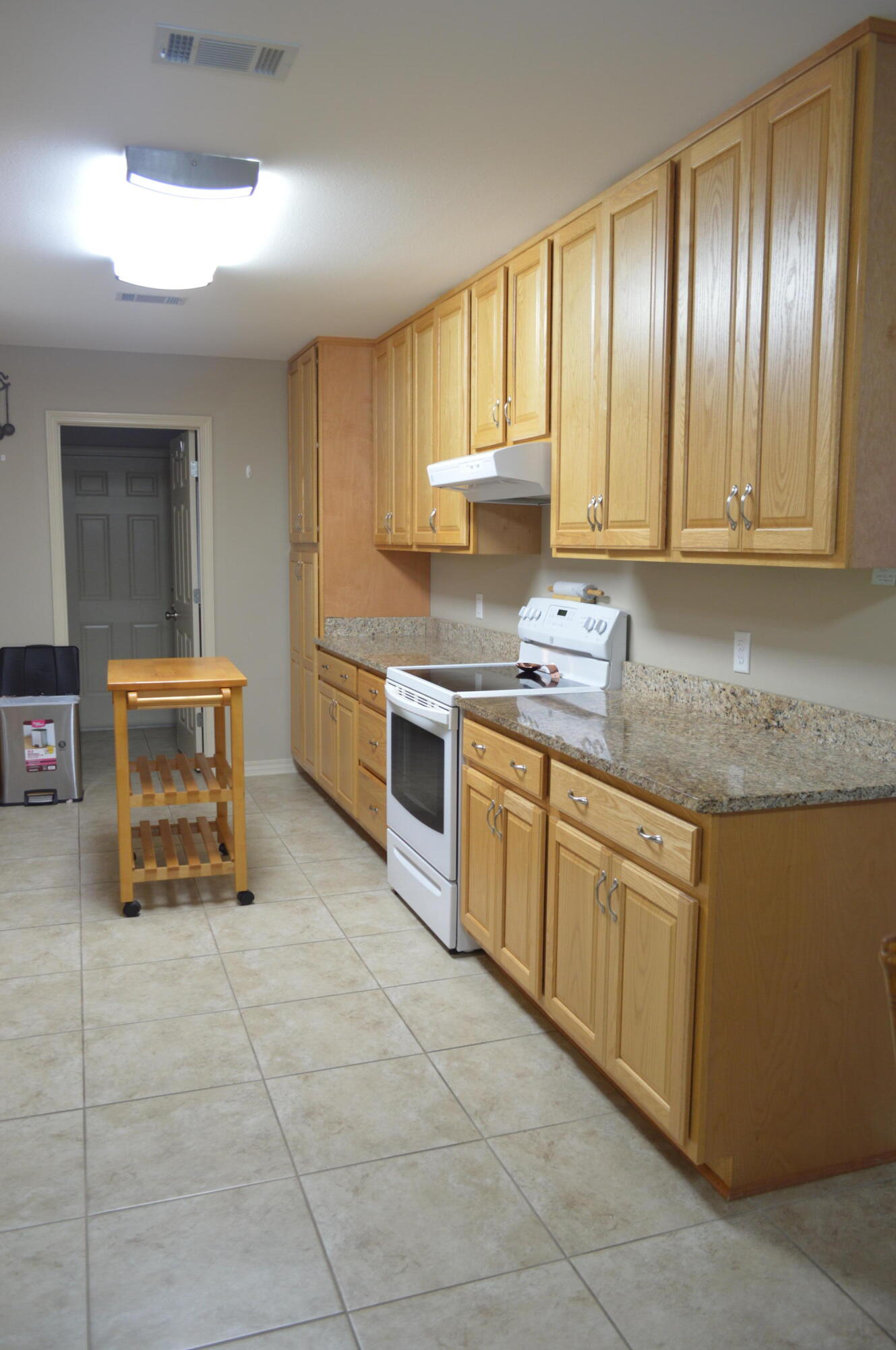 3939 Painter Branch Road Crestview, FL 32539 - Photo 8 of 35 a kitchen with stainless steel appliances granite countertop a stove a sink and a microwave