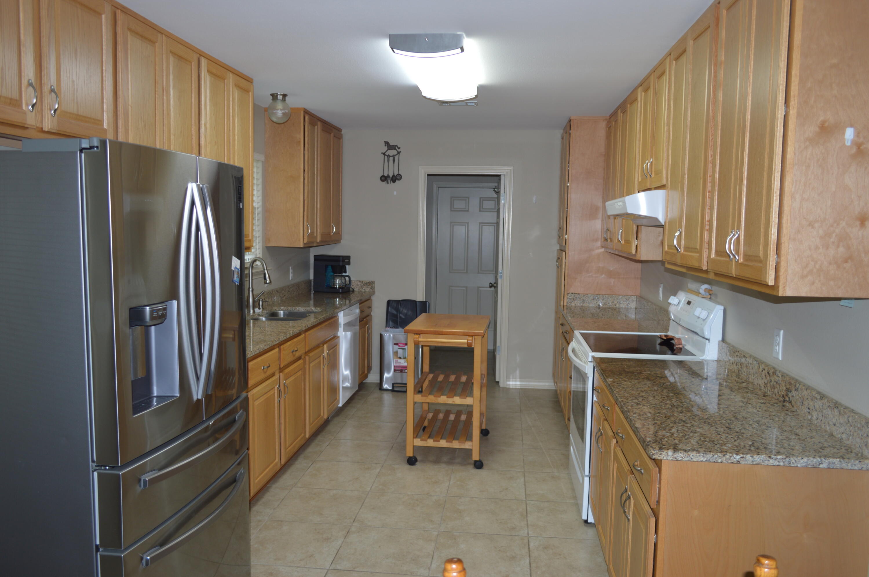 3939 Painter Branch Road Crestview, FL 32539 - Photo 9 of 35 a kitchen with granite countertop a refrigerator and a sink