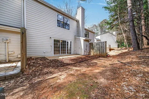 a front view of a house with a tree