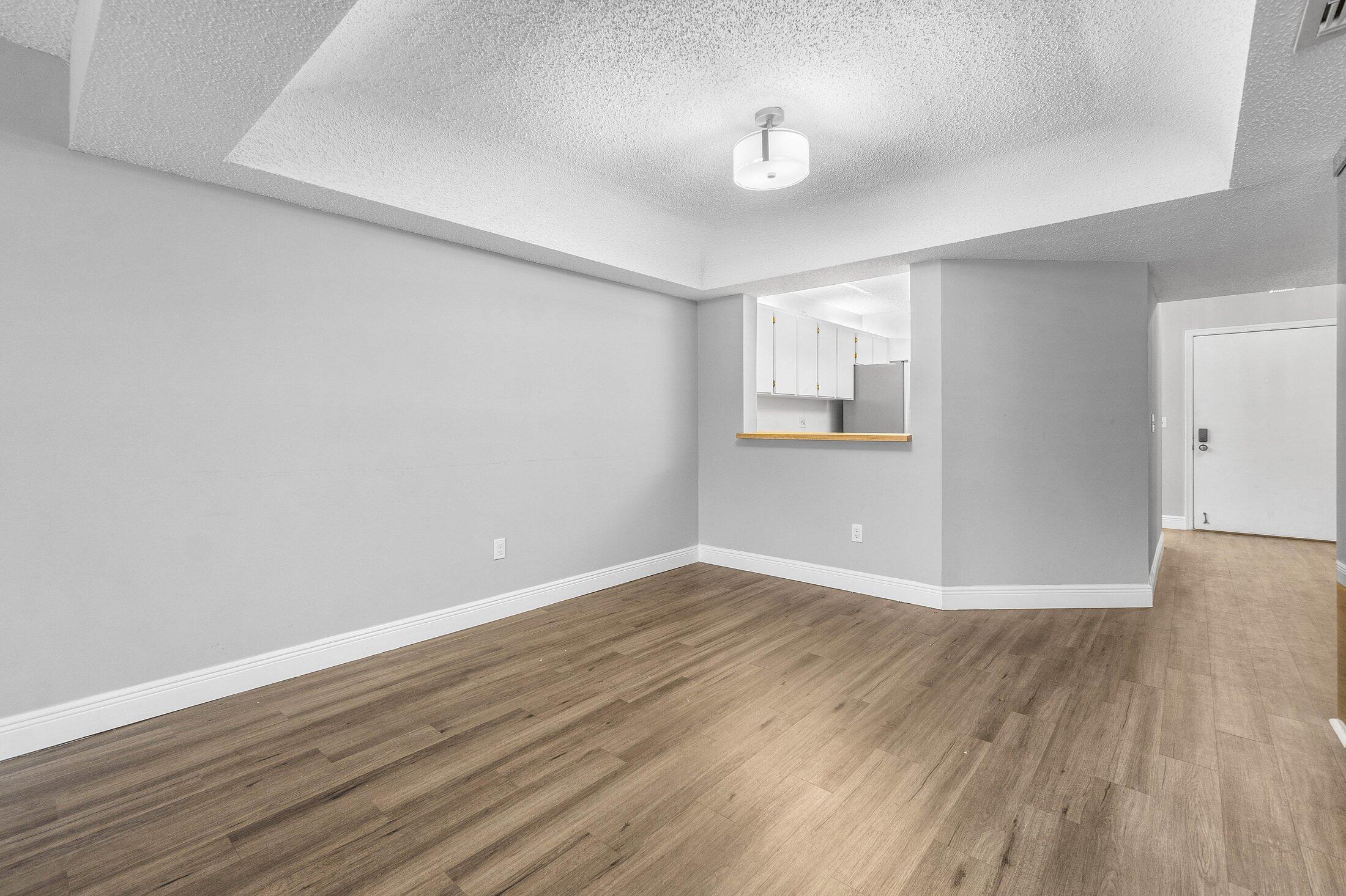23395 Carolwood Lane, Unit 207 Boca Raton, FL 33428 - Photo 12 of 39 a view of wooden floor and windows in a room