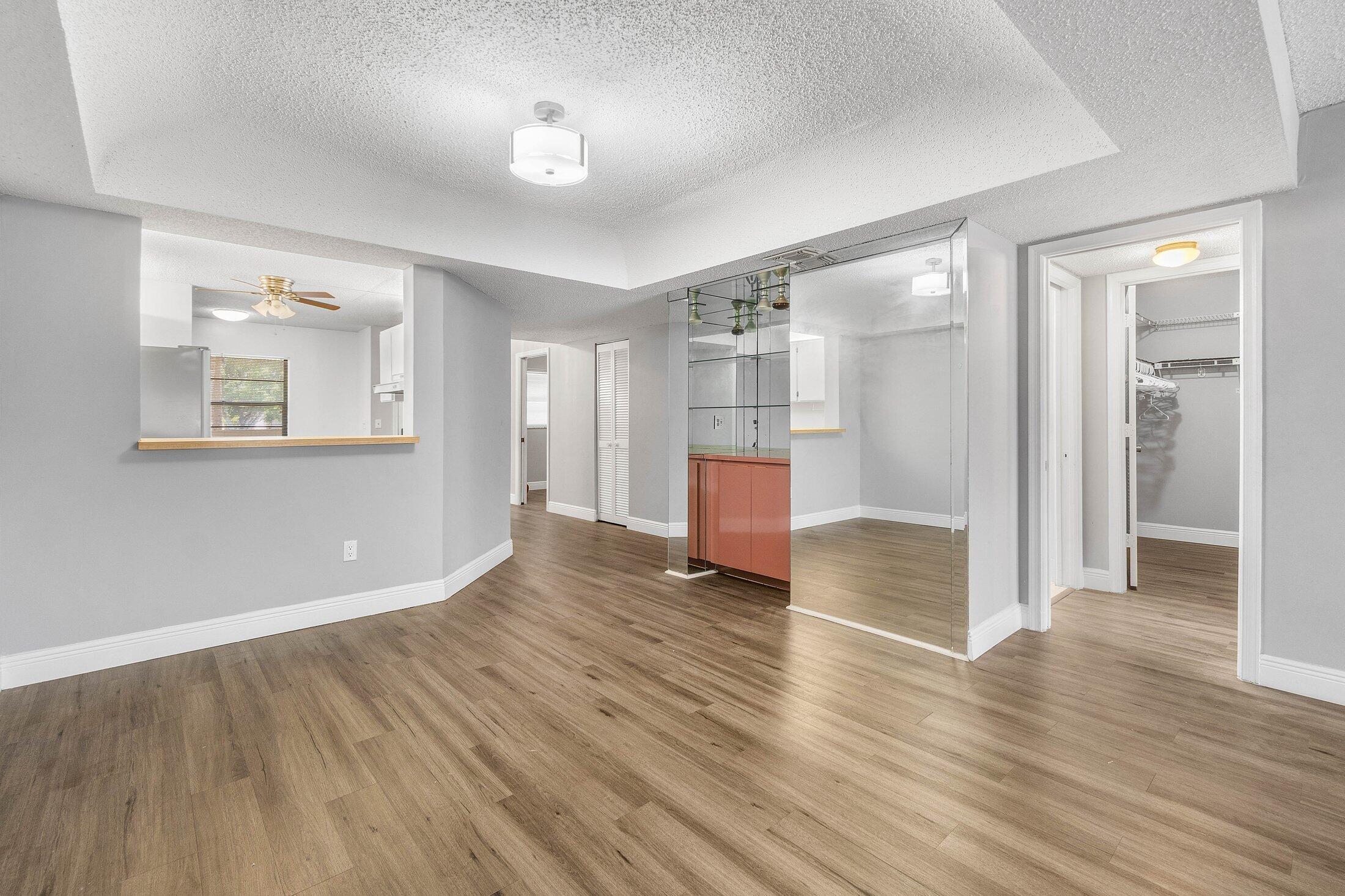 23395 Carolwood Lane, Unit 207 Boca Raton, FL 33428 - Photo 14 of 39 a view of empty room with wooden floor
