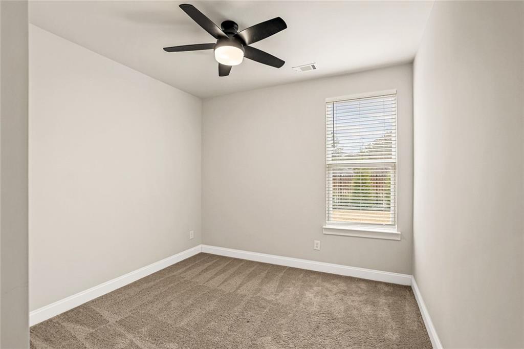 639 Tigers Eye Terrace Kennesaw, GA 30144 - Photo 13 of 36 an empty room with a window and a fan