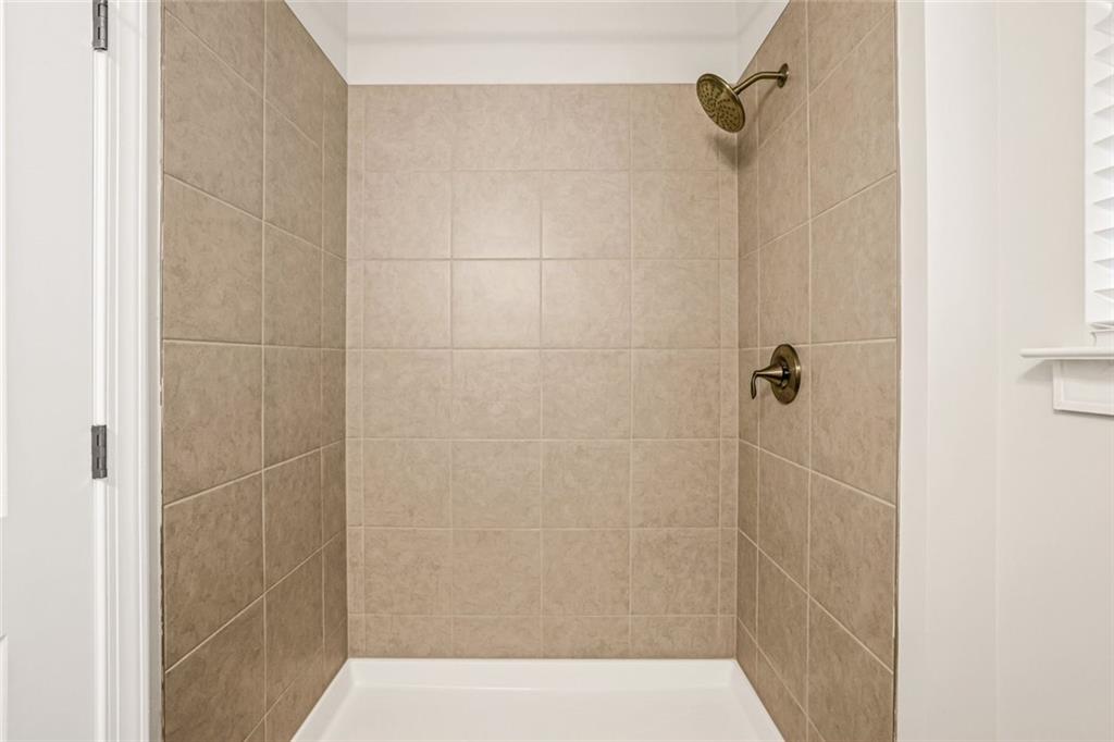 639 Tigers Eye Terrace Kennesaw, GA 30144 - Photo 16 of 36 a bathroom with a shower