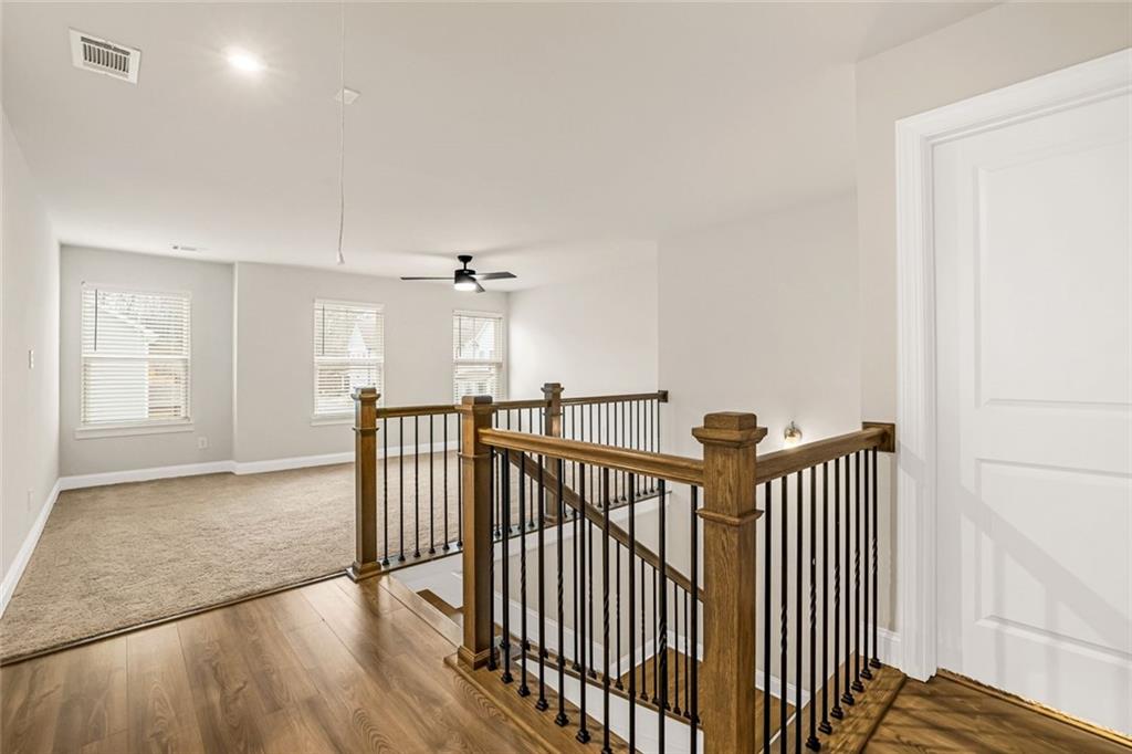 639 Tigers Eye Terrace Kennesaw, GA 30144 - Photo 17 of 36 a view of a hallway with wooden floor and windows