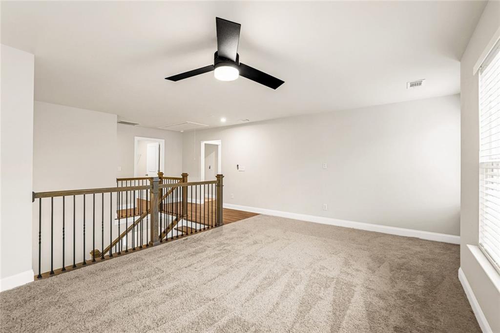 639 Tigers Eye Terrace Kennesaw, GA 30144 - Photo 18 of 36 an empty room with ceiling fan and windows