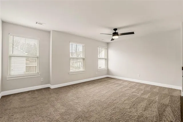 a view of a livingroom with a ceiling fan and window
