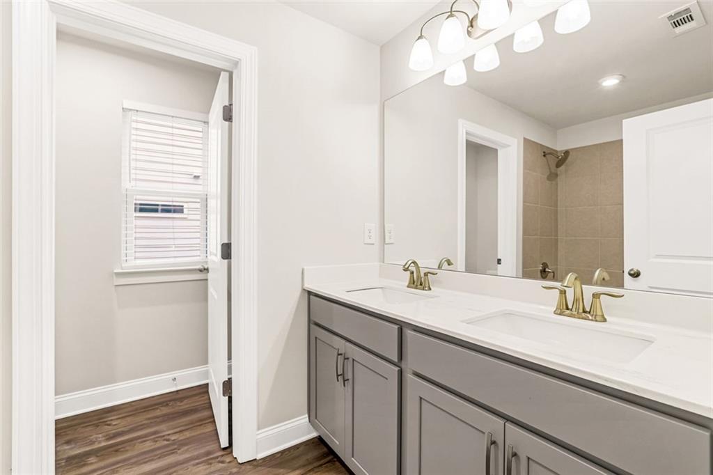 639 Tigers Eye Terrace Kennesaw, GA 30144 - Photo 23 of 36 a bathroom with a sink a vanity and a mirror